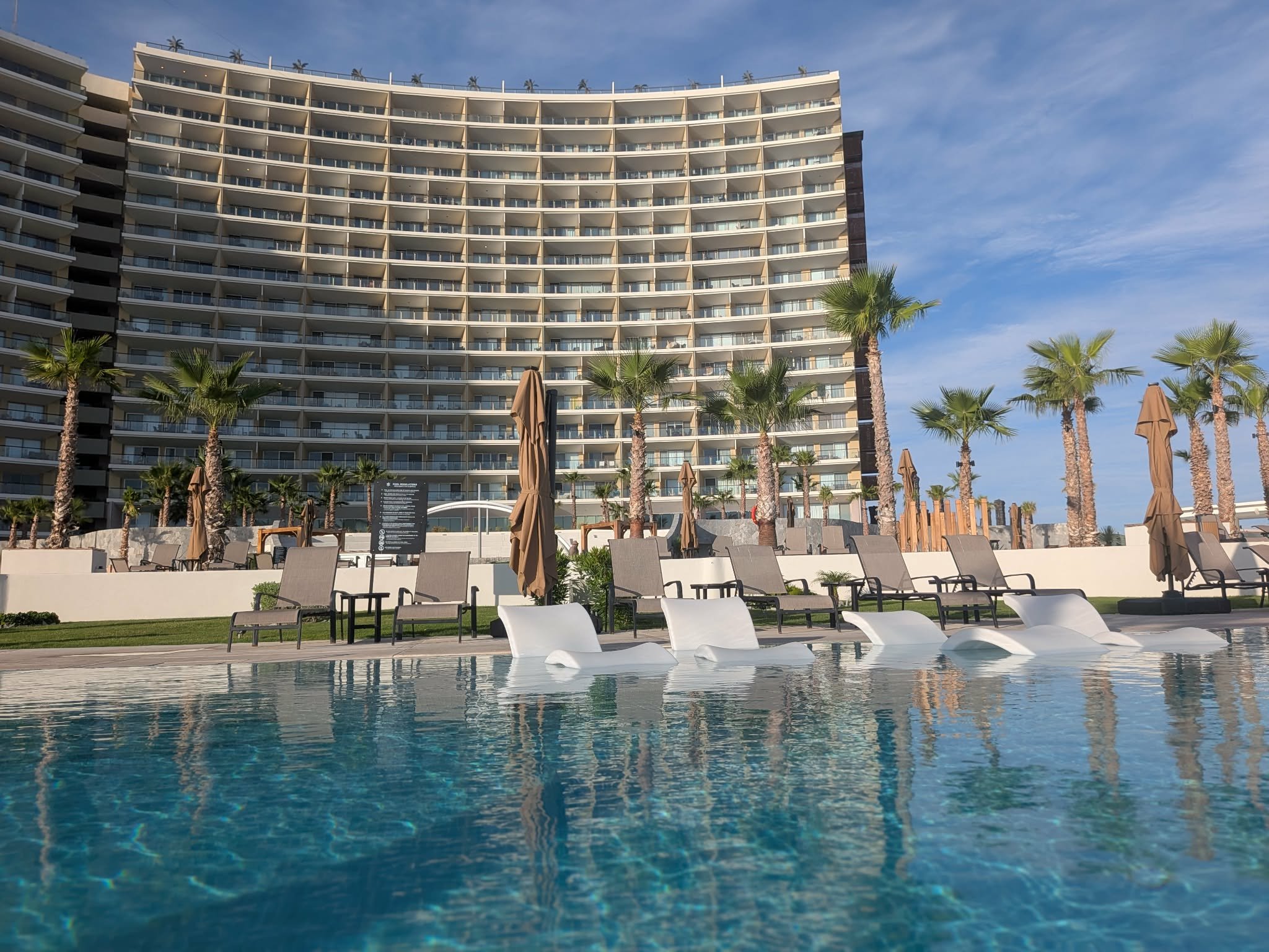 Curved Sonoran Star resort tower rising above a pool